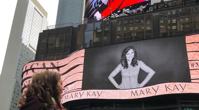 Frantz was featured on a Mary Kay billboard in Times Square in New York City. She is shown looking at her image on the digital board.