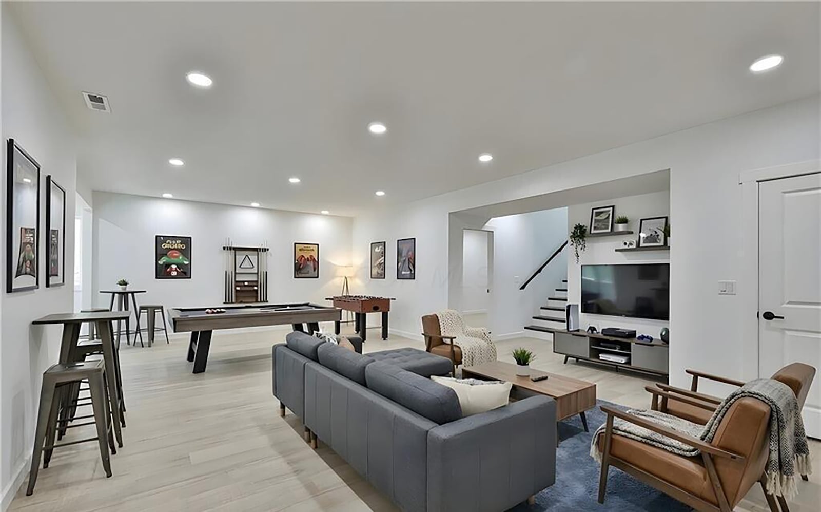 The finished basement features a family room with LVP flooring and a wet bar and recessed lighting. CONTRIBUTED