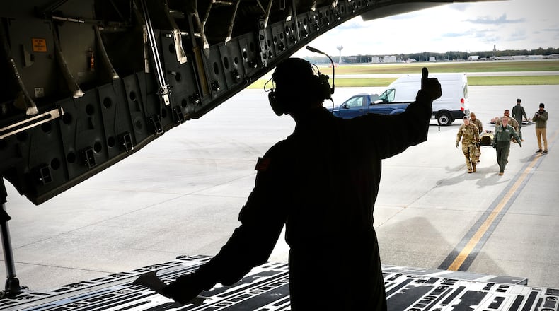 The C-17 Globemaster III crew load dummies onto the plane during a mock evacuation drill Wednesday, October 16, 2024 at Wright Patterson Air Force base. The Pentagon is developing proposals that cut permanent change of station budgets in half by fiscal 2030. MARSHALL GORBY \STAFF