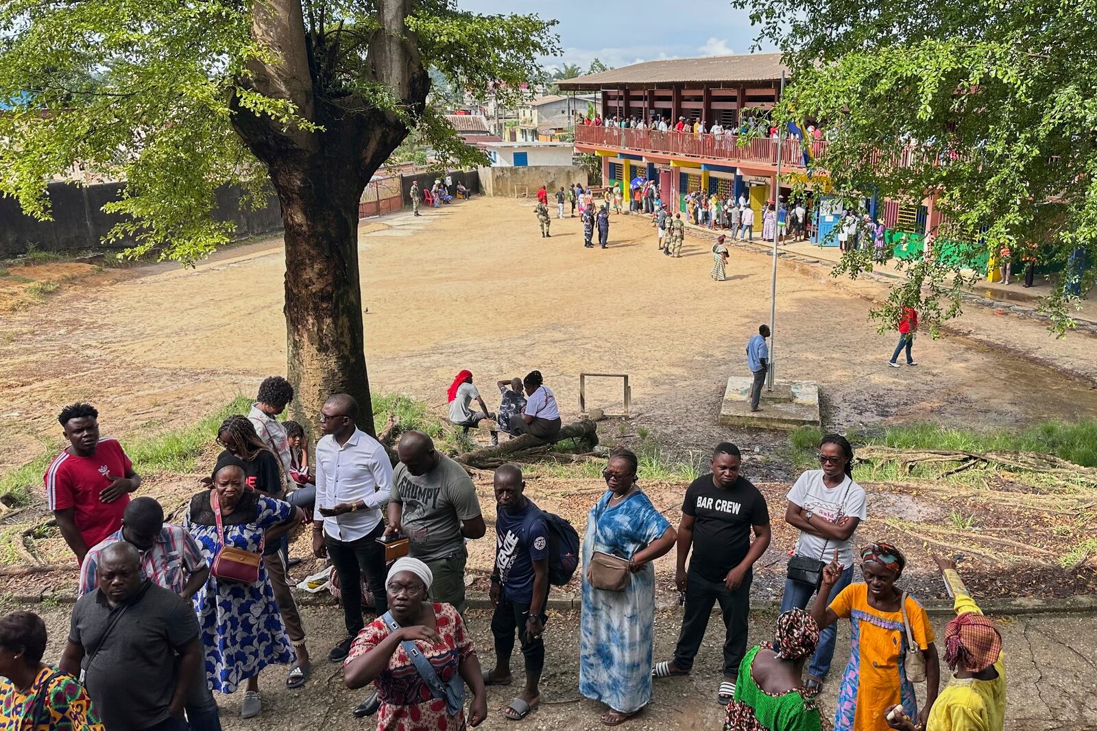 Voters queue to cast their votes for the presidential elections outside a polling station, in Liberville, Gabon, Saturday, April 12, 2025. (AP Photo/Betines Makosso)