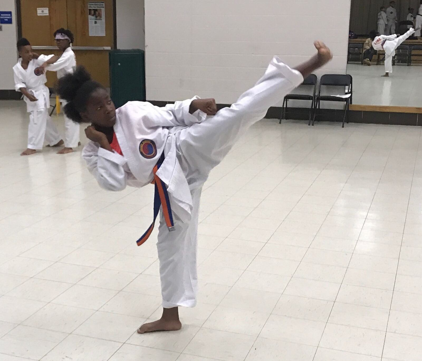 Sidnei Byrd kicks during a forms drill Monday evening at Princeton Park. Tom Archdeacon/CONTRIBUTED