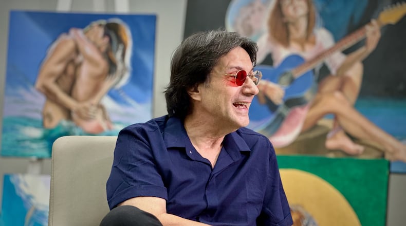 Fernando Dávila, a colorblind painter, speaks during an interview with The Associated Press at his gallery in Doral, Fla. on Thursday, Dec. 18, 2025. (AP Photo/Cody Jackson)