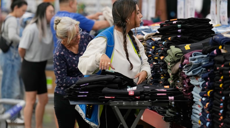 A worker stocks a display of clothing at a Sam's Club, Wednesday, Sept. 24, 2025, in Bentonville, Ark. (AP Photo/Charlie Riedel)