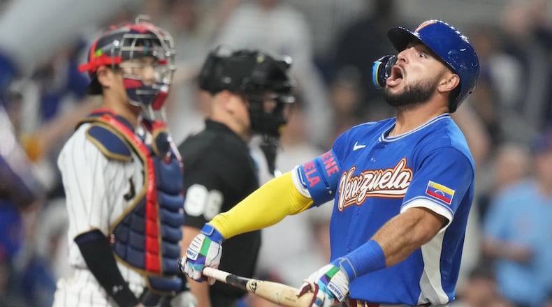 Venezuela's Wilyer Abreu celebrates with his teammates after he hit a home run during the six inning of a World Baseball Classic quarterfinal game against Japan, Saturday, March 14, 2026, in Miami. (AP Photo/Lynne Sladky)