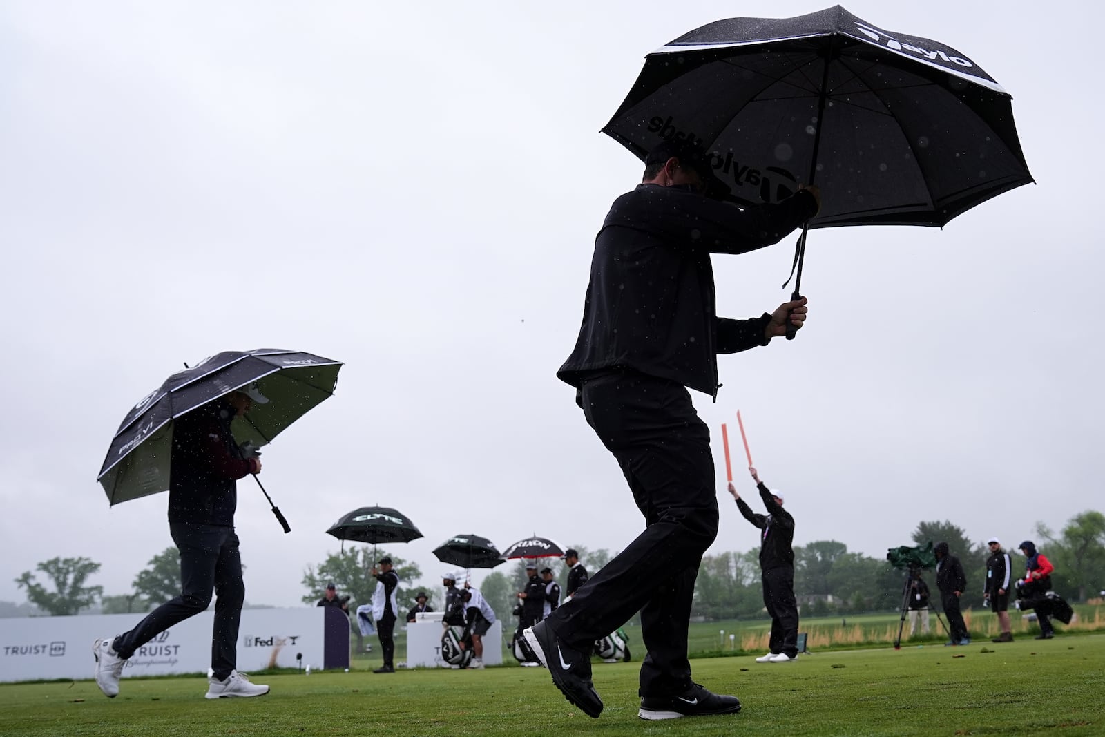 Rory McIlroy, right, of Northern Ireland, and Justin Thomas walk on the 14th hole during the second round of the Truist Championship golf tournament at the Philadelphia Cricket Club, Friday, May 9, 2025, in Flourtown. (AP Photo/Matt Rourke)
