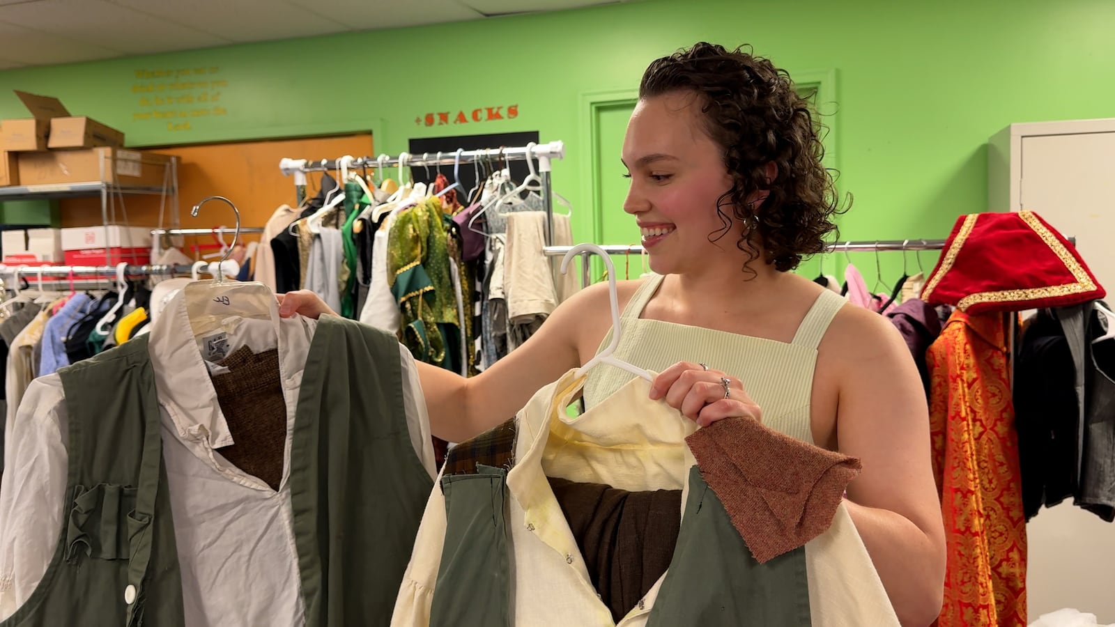 Costume designer Catherine NguyenLu assesses Shrek's shirts. Photo by David Sherman