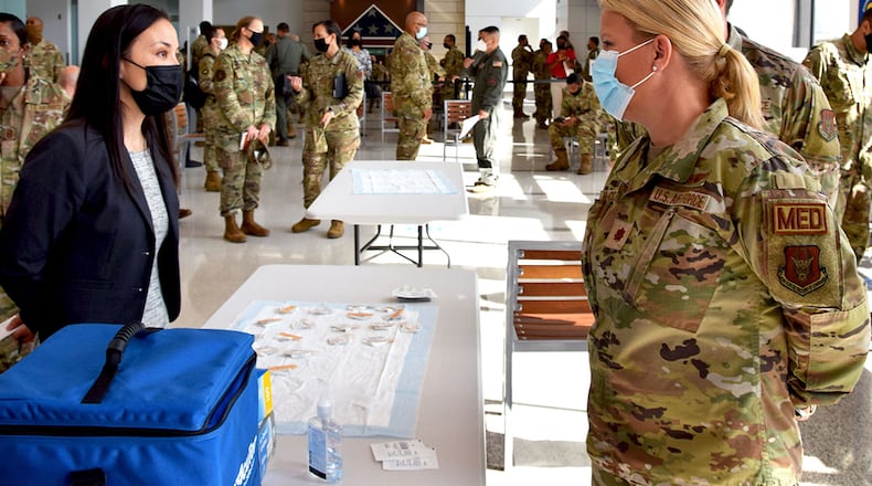 Under Secretary of the Air Force Gina Ortiz Jones speaks with Maj. Molly McCowan, 433rd Medical Squadron clinical nurse, during her visit to 433rd Airlift Wing members at Wilford Hall Ambulatory Surgical Center, Joint Base San Antonio-Lackland, Texas, to view COVID-19 vaccination efforts Oct. 2, 2021. U.S. AIR FORCE PHOTO/TECH SGT. SAMANTHA MATHISON