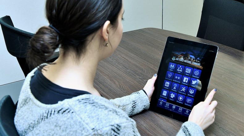 Lindsay McNeely navigates through the Newcomer Feature on the Air Force Materiel Command instance of the Air Force Connect Mobile App. The feature aims to make the on-boarding process and first days of work easier for civilian new hires by providing employees with step-by-step pre-employment and on-boarding process information, checklists, installation maps, pay and benefits data, and more. (Air Force photo/Marisa Alia-Novobilski)