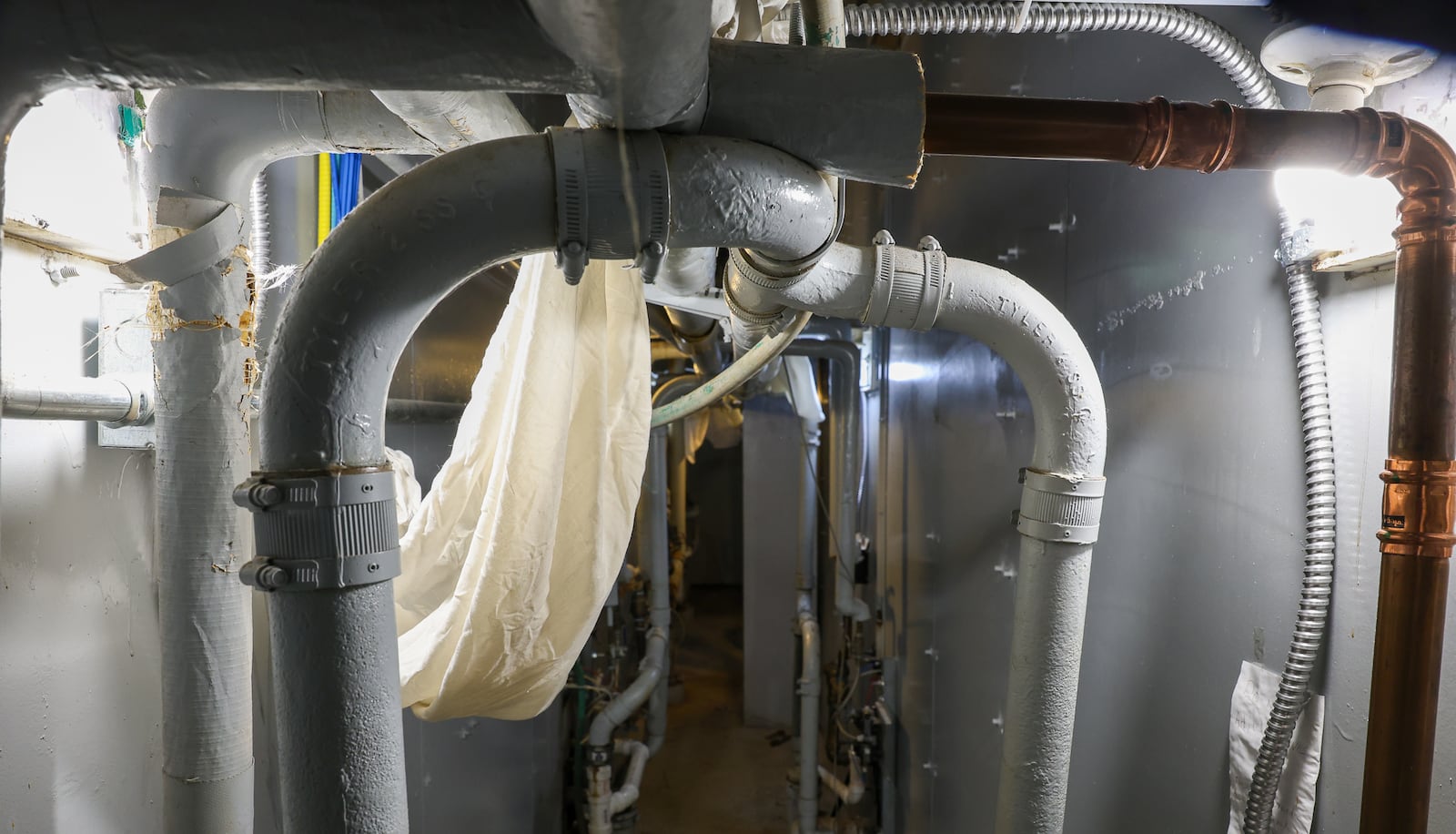 A view of piping behind a cell block in the Miami County Jail, the county's maximum security facility in the safety building in downtown Troy. Assistant jail administrator Nate Collett said maintenance workers have to "constantly fight" to keep plumbing operational. BRYANT BILLING / STAFF