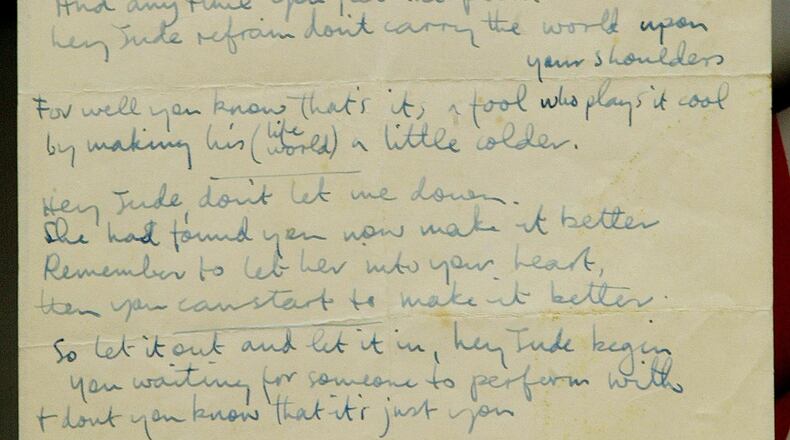 A Christie’s porter displays a rare page of handwritten lyrics of the Beatles’ best-selling single ever “Hey Jude” in April 2002. The item sold for $910,000 during an April 10, 2020, Beatlemania auction at Julien’s Auctions.