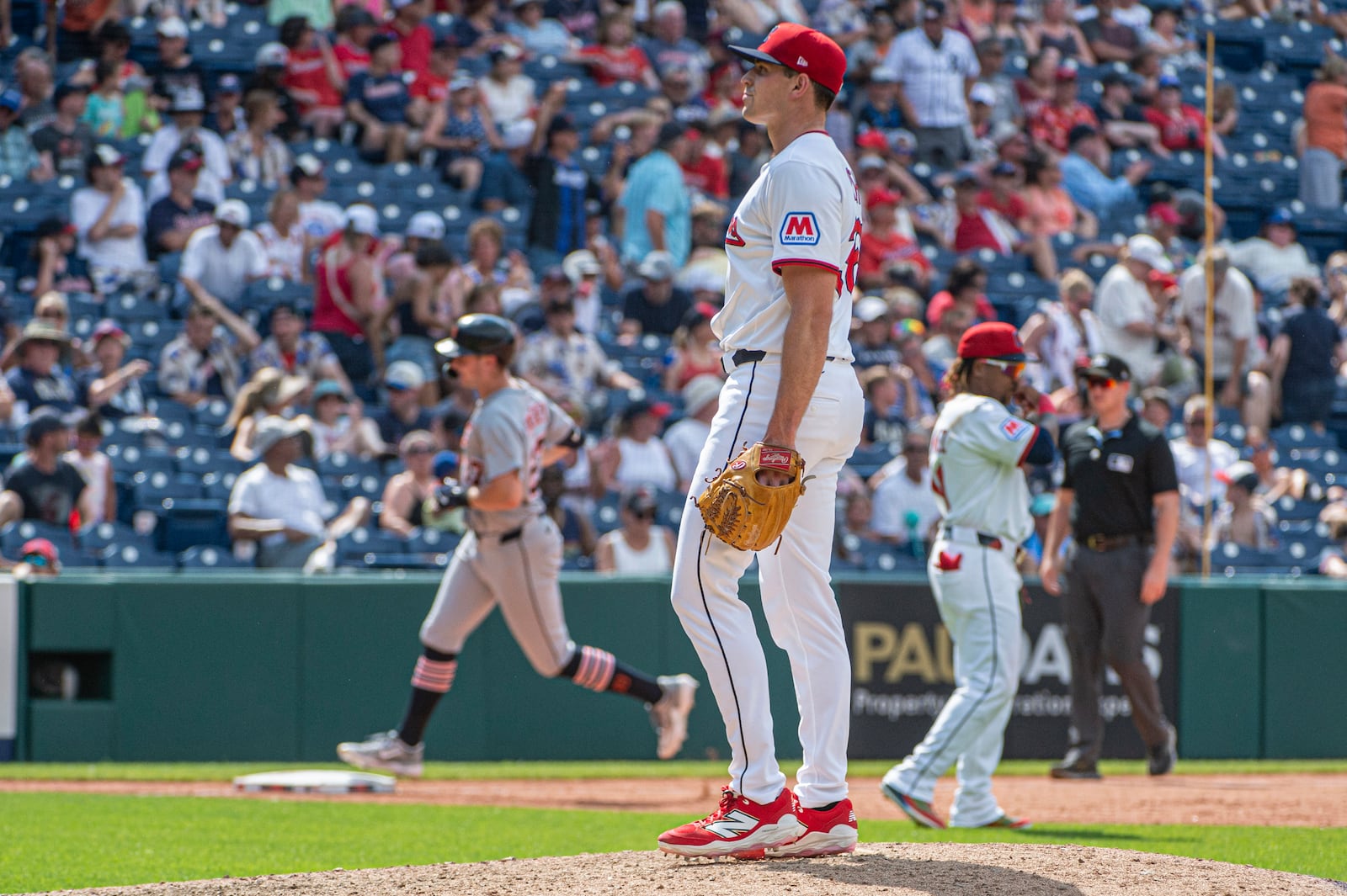 Cleveland Guardians relief pitcher Cade Smith, foreground, looks to home plate as Detroit Tigers' Trey Sweeney, back left, rounds the bases after hitting a three-run home run inning of a baseball game, Sunday, July 6, 2025, in Cleveland. (AP Photo/Phil Long)