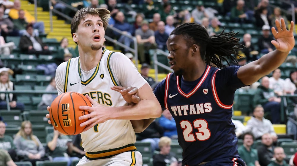 Wright State freshman forward Kellen Pickett dribbles with pressure from Detroit Mercy's Legend Geeter during a Horizon League game on Thursday, Feb. 12 at Ervin J. Nutter Center in Fairborn. BRYANT BILLING / STAFF