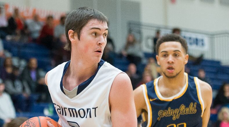 Fairmont junior forward Cade Morgan grabs a rebound with pressure from Springfield’s Dominique Parks during a Greater Western Ohio Conference game against on Tuesday night at Trent Arena. Contributed Photo by Bryant Billing