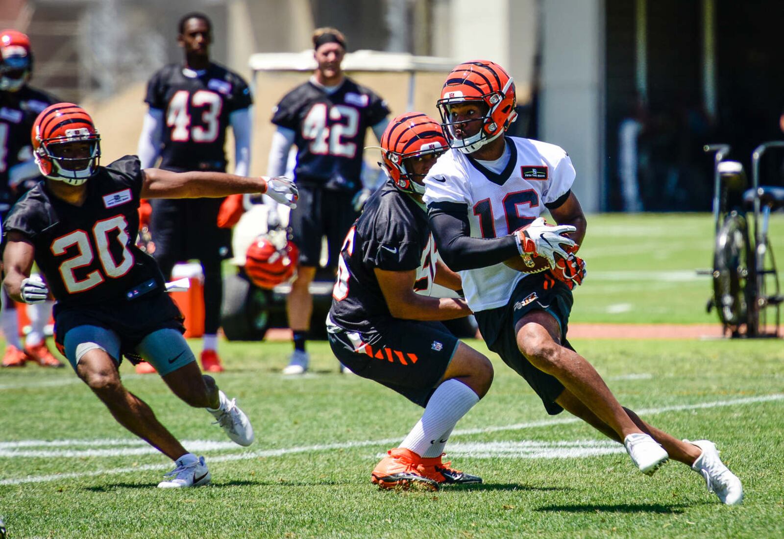Cincinnati Bengals wide receiver Cody Core carries the ball during practice Tuesday, June 6 on their practice fields next to Paul Brown Stadium in Cincinnati. NICK GRAHAM/STAFF