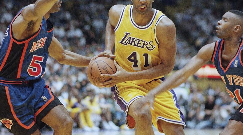 FILE - Elden Campbell (41) of the Los Angeles Lakers drives to the basket as Buck Williams left, and Charlie Ward of the New York Knicks defend, during the second half of their game on Sunday, Feb. 23, 1997 in Inglewood, Calif. (AP Photo/Mark J. Terrill, File)