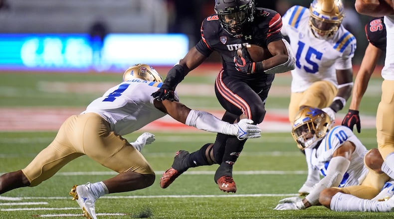 Utah running back Tavion Thomas (9) carries the ball for a touchdown as UCLA defensive back Stephan Blaylock (4) tries to defend in the second half during an NCAA college football game Saturday, Oct. 30, 2021, in Salt Lake City. (AP Photo/Rick Bowmer)