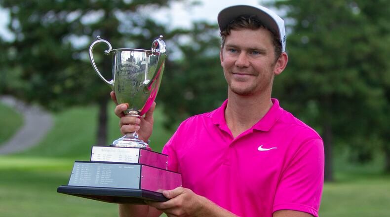 Mikkel Mathiesen holds the Metro championship trophy for the second straight year Sunday after a four-shot win at Heatherwoode Golf Club. Jeff Gilbert/CONTRIBUTED