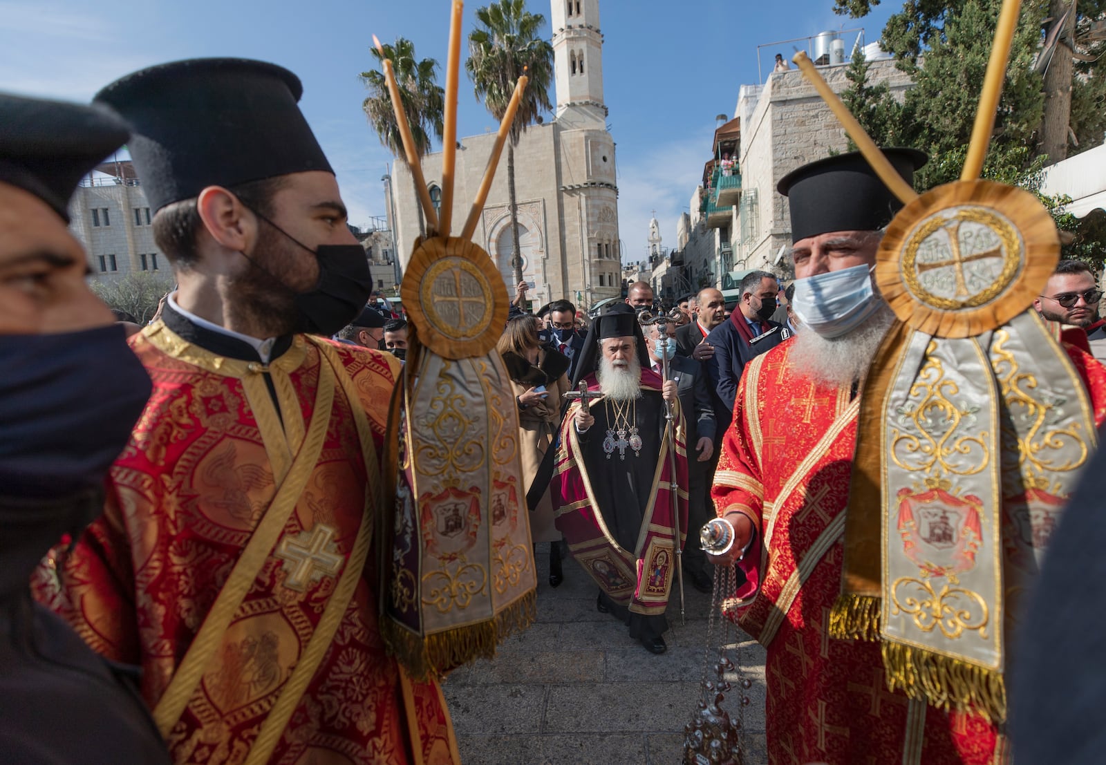 FILE -Greek Orthodox Patriarch of Jerusalem Theophilos III, center, arrives for Christmas celebrations, according to the Eastern Orthodox calendar, outside the Church of the Nativity, traditionally recognized by Christians to be the birthplace of Jesus Christ, in the West Bank city of Bethlehem, Jan. 6, 2021. (AP Photo/Nasser Nasser), File)