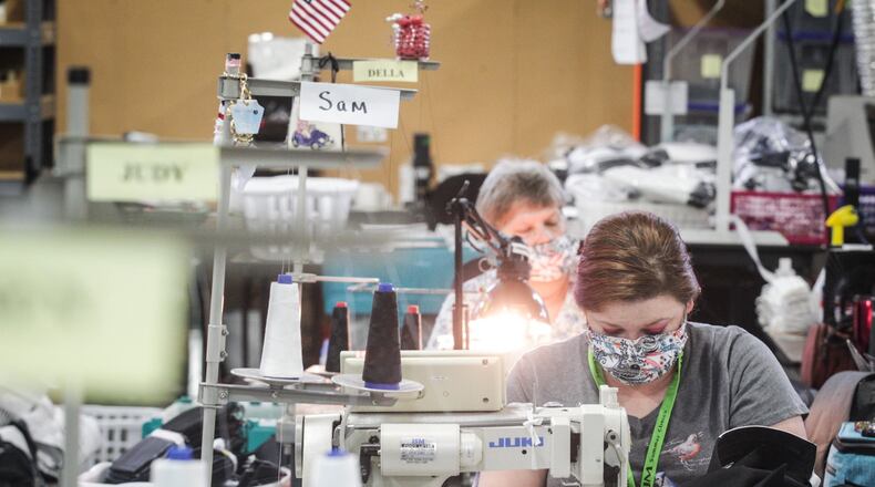 Sam Baker is back to work after six weeks off at FJM in Miamisburg. The company makes marching band uniforms, and they’re resuming normal production today, after six weeks of making face masks. JIM NOELKER/STAFF