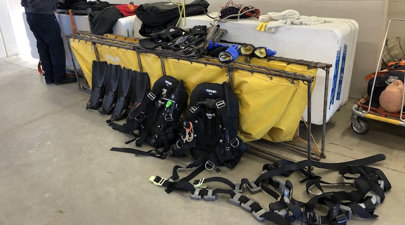 Turtlecreek Twp. Assistant Fire Chief Mike Jameson tending to dive gear used on Monday night to recover the horse drowned in a pond during a harness race at the Miami Valley Gaming racino. STAFF/LAWRENCE BUDD