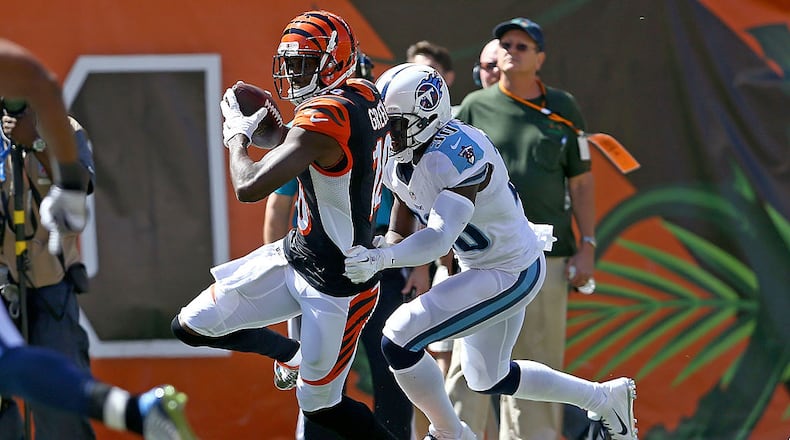 CINCINNATI, OH - SEPTEMBER 21: Jason McCourty #30 of the Tennessee Titans tackles A.J. Green #18 of the Cincinnati Bengals during the first quarter at Paul Brown Stadium on September 21, 2014 in Cincinnati, Ohio. (Photo by Andy Lyons/Getty Images)