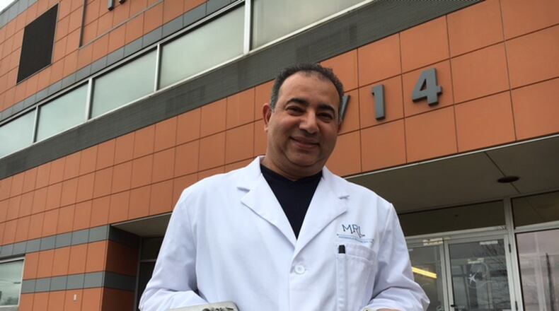 Ayman Salem, founder of Materials Resources LLC, holds examples of metals carefully crafted with 3-D printing processes in his lab.  THOMAS GNAU/STAFF
