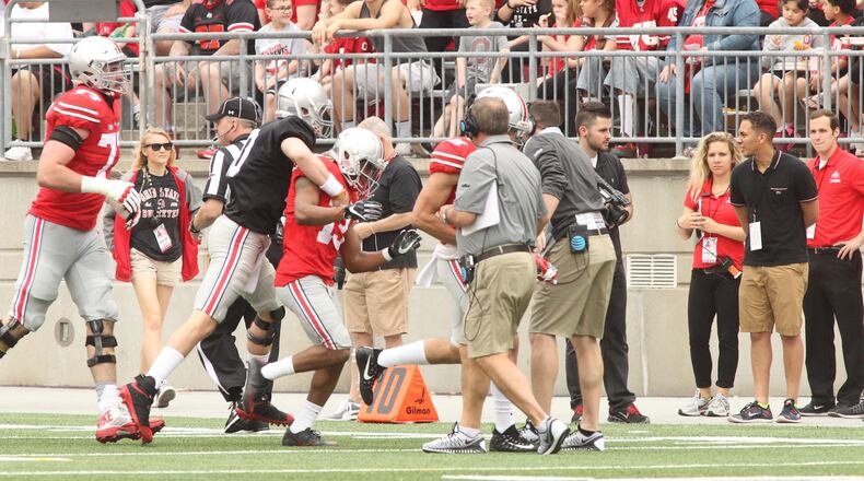 Joe Burrow congratulates Ke’Von Huguely after the two connected on a touchdown in the first half of the spring game on Saturday, April 15, 2017, at Ohio Stadium in Columbus. David Jablonski/Staff