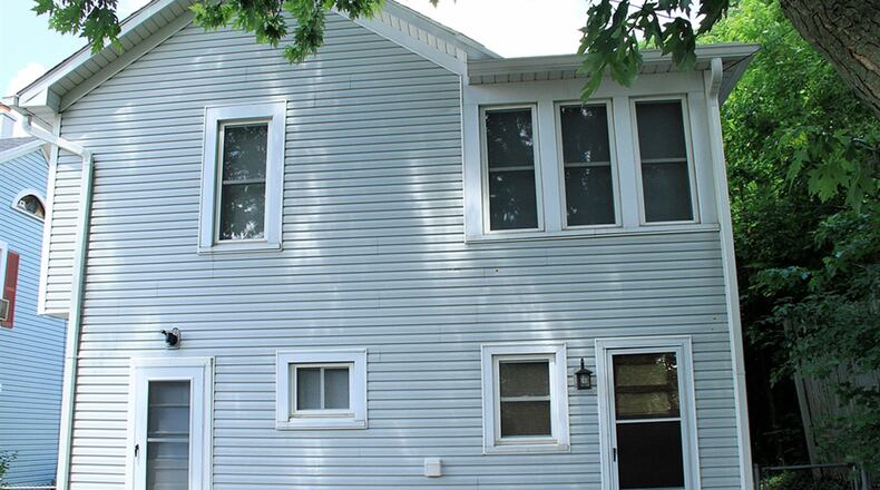 A door opens from the breezeway off the kitchen and another door opens off the den into the back yard, which is fenced and has a storage shed.
