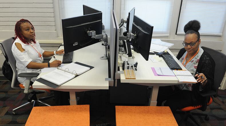 Kina Johnson, left, and Natajah Williams, Client Support Coordinators, at the YWCA Rape Crisis Center in downtown Dayton. MARSHALL GORBY\STAFF
