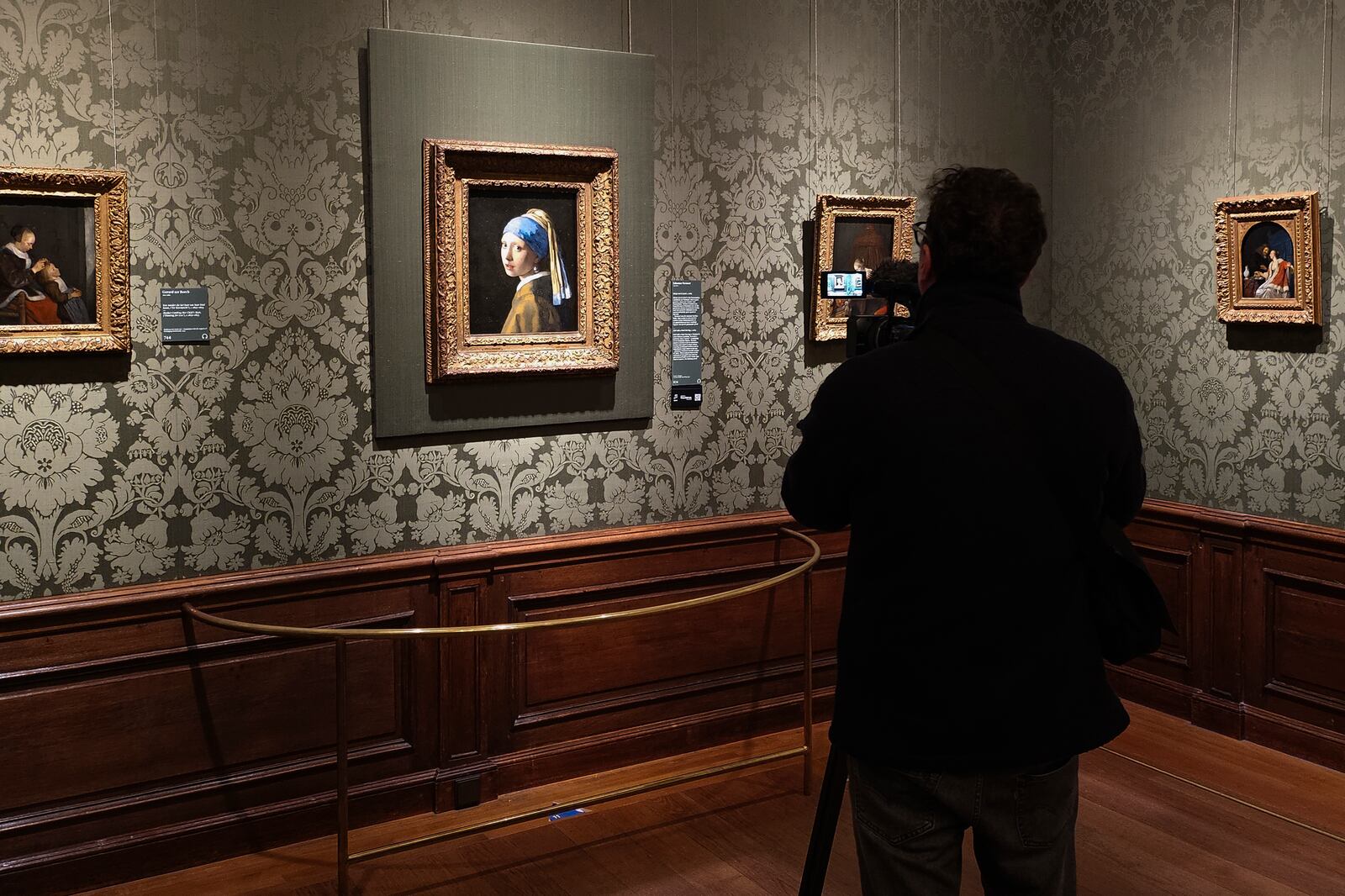 A video journalist takes images of "Girl with a Pearl Earring," painting by Johannes Vermeer, at The Mauritshuis museum in The Hague, Netherlands, Tuesday, March 25, 2025. (AP Photo/Molly Quell)