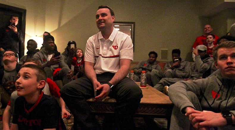 Dayton coach Archie Miller watches the NCAA tournament selection show at his house in Kettering on Sunday, March 12, 2017. David Jablonski/Staff