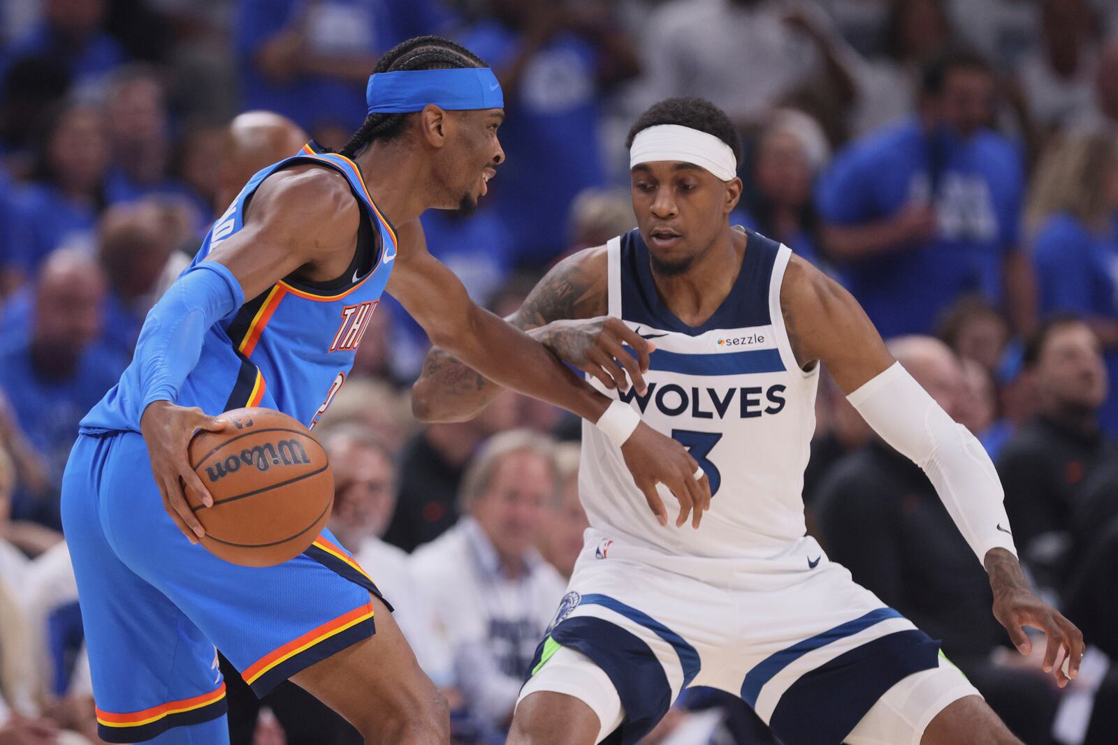 Oklahoma City Thunder guard Shai Gilgeous-Alexander (2) works toward the basket as Minnesota Timberwolves forward Jaden McDaniels (3) defends during the first half of Game 5 of the Western Conference finals of the NBA basketball playoffs, Wednesday, May 28, 2025, in Oklahoma City. (AP Photo/Nate Billings)