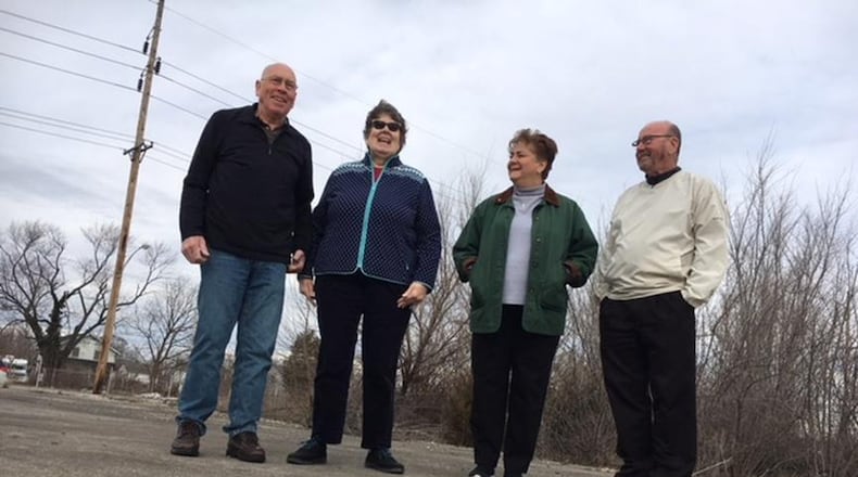 Dayton-area Delphi salaried retirees (from left), Tom Rose, Mary Miller, Marlane Bengry and Tom Green, standing on the foundation of the former Delphi Wisconsin Boulevard plant in Dayton. This photo was taken in March 2018. THOMAS GNAU/STAFF