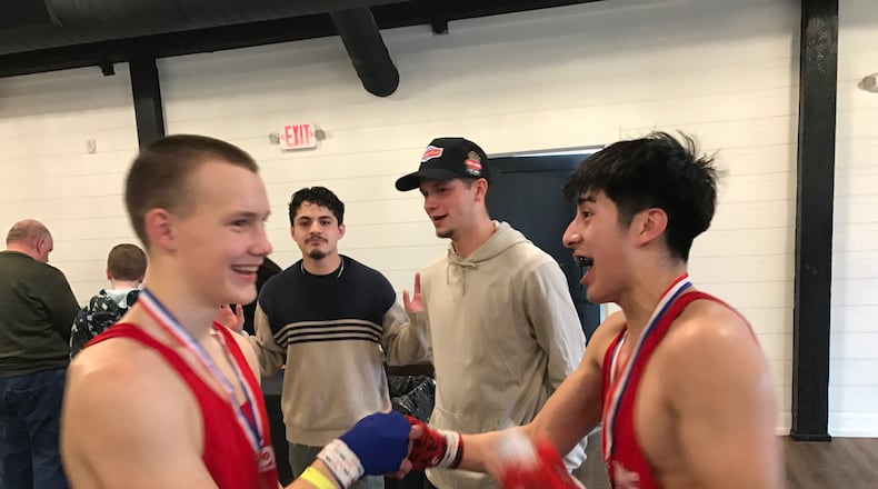 Wright State student Emanuel Bacon, a DMC Boxing welterweight who was born in Michigan but is of Guatemalan heritage is congratulated after his victory Saturday by stablemate Stas Burylenko, a 16-year middleweight who came from Odessa, Ukraine and also was a winner on the amateur fight card held at The Lift in East Dayton. Tom Archdeacon/CONTRIBUTED