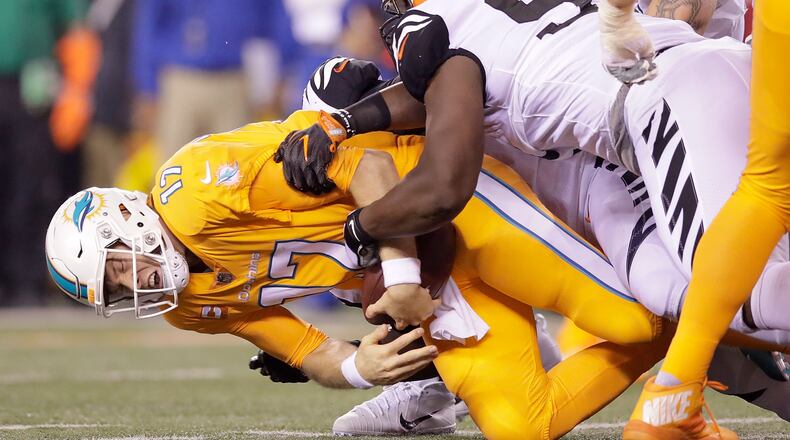 CINCINNATI, OH - SEPTEMBER 29: Ryan Tannehill #17 of the Miami Dolphins is tackled by Geno Atkins #97 of the Cincinnati Bengals during the fourth quarter at Paul Brown Stadium on September 29, 2016 in Cincinnati, Ohio. Cincinnati defeated Miami 22-7. (Photo by Andy Lyons/Getty Images)