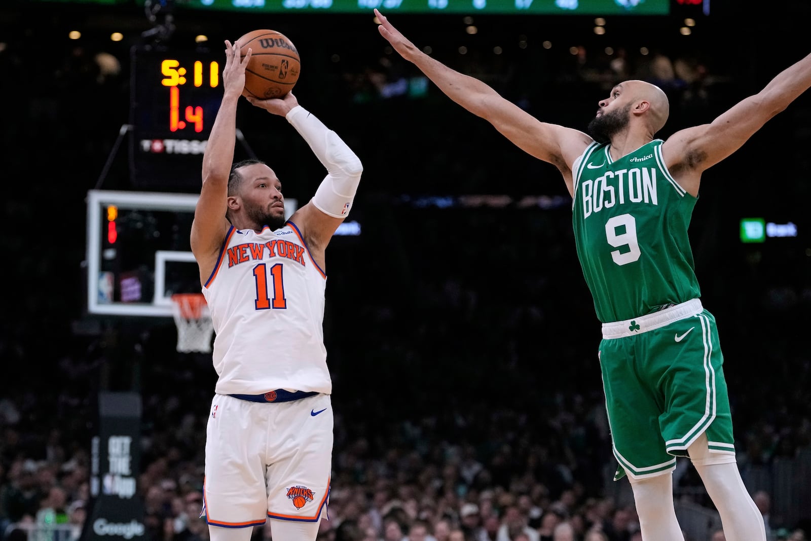 New York Knicks guard Jalen Brunson (11) takes a 3-point shot against Boston Celtics guard Derrick White (9) during the second half of Game 2 of an NBA basketball second-round playoff series, Wednesday, May 7, 2025, in Boston. (AP Photo/Charles Krupa)