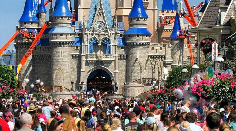 Crowds jam Main Street USA in front of Cinderella Castle in the Magic Kingdom, at Walt Disney World in Lake Buena Vista, Fla., Thursday, March 12, 2020. Walt Disney World announced Thursday night that it will close the central Florida theme parks starting Monday through the end of the month. (Joe Burbank/Orlando Sentinel via AP) (Joe Burbank/AP)