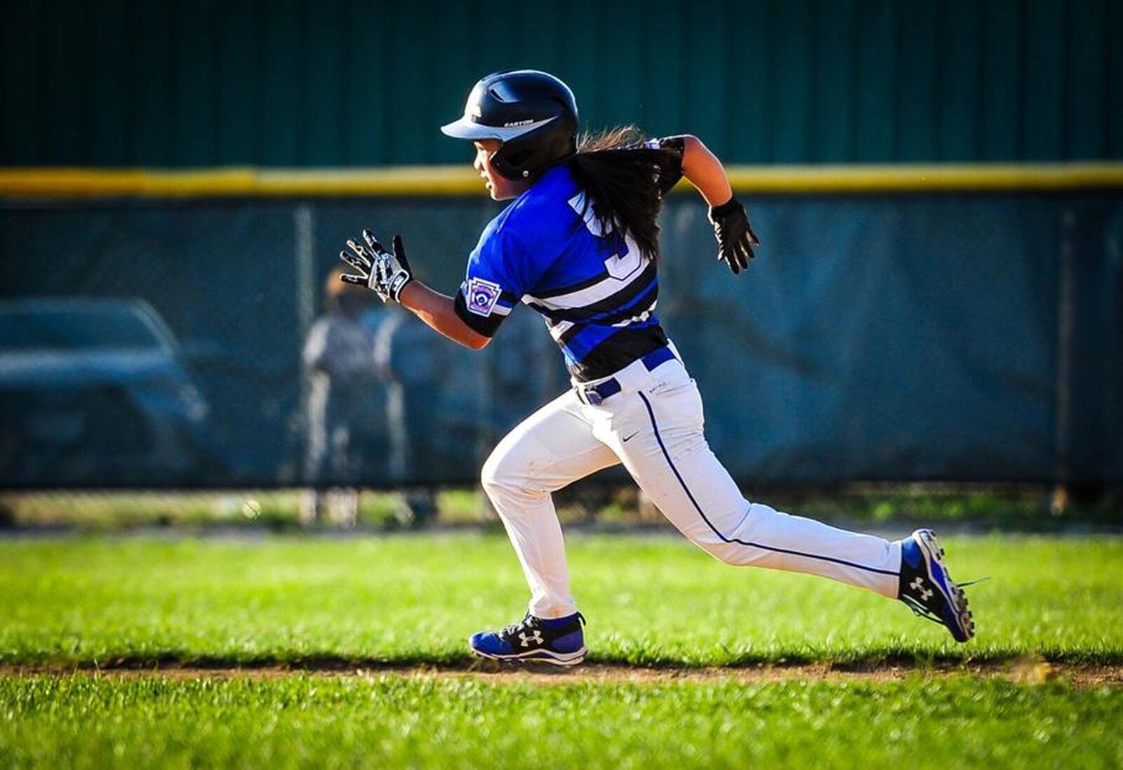 Hamilton West Side Little League’s Katelyn Polido shows off her speed on the bases during the District 9 championship game against Lebanon on July 10 at the West Side complex in Hamilton. NICK GRAHAM/STAFF