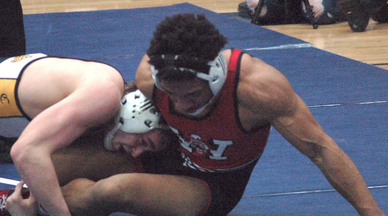 Centerville’s Drew Wiechers finishes off the winning takedown as time expires to win the GWOC title at 152 pounds over Wayne’s Jordan Hardrick Saturday night at Trent Arena. John Cummings/CONTRIBUTED