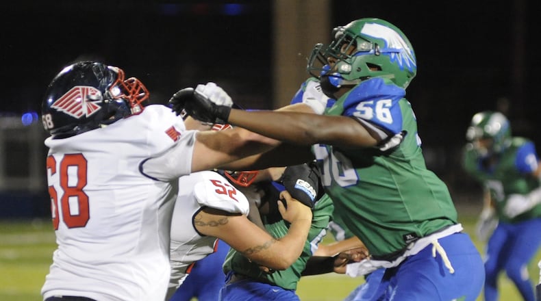 Caden Clark (left) of Piqua matches up with Chaiminde Julienne’s Shane Cokes. CJ defeated visiting Piqua 42-22 in a Week 1 high school football game on Friday, Aug. 24, 2018. MARC PENDLETON / STAFF