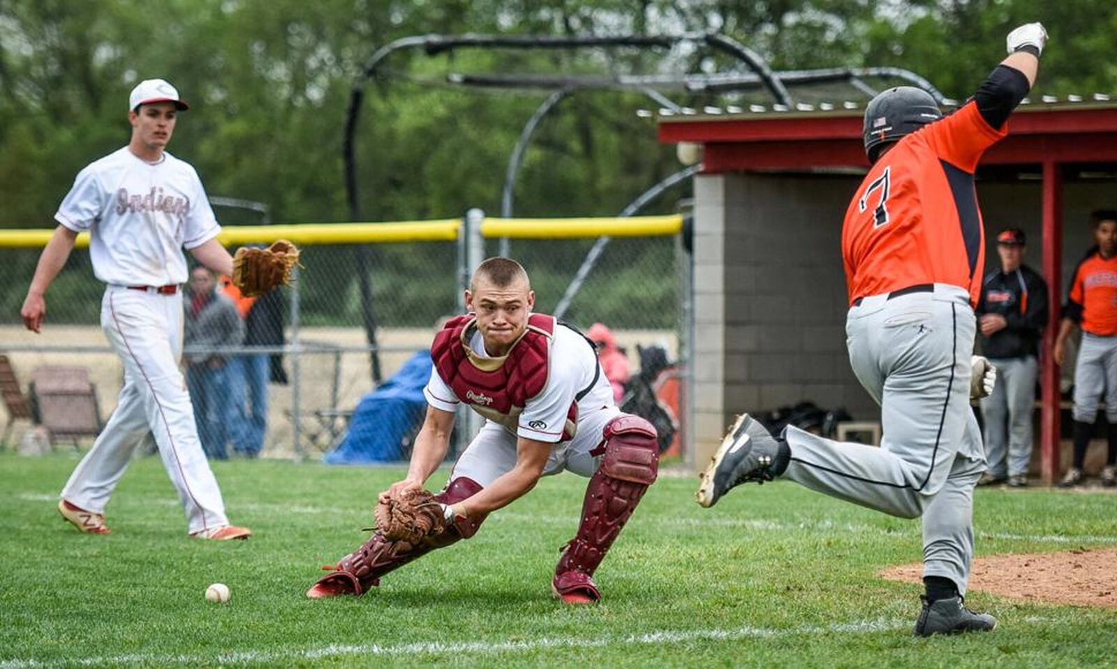 Waynesville’s Luke Moore (7) beats Carlisle catcher Dane Flatter to the plate to score on a sacrifice fly during Monday’s game at Carlisle’s Sam Franks Field. That’s CHS pitcher Adam Goodpaster watching the play. NICK GRAHAM/STAFF