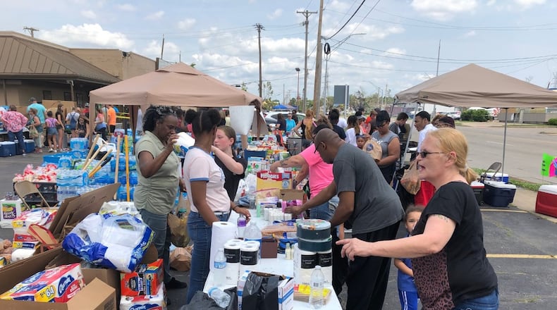 In early June, volunteers in Old North Dayton gave out free food, water and other supplies to victims of the Memorial Day tornadoes. STAFF / DREW TANNER