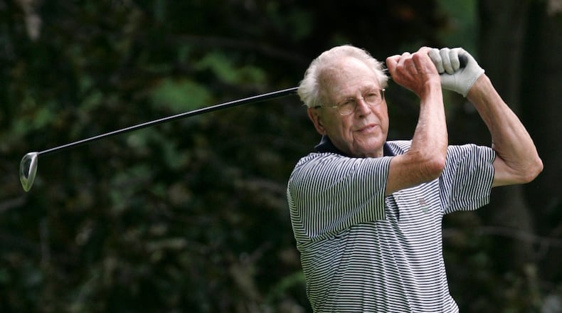 Frank Worley follows through on a golf shot. File photo