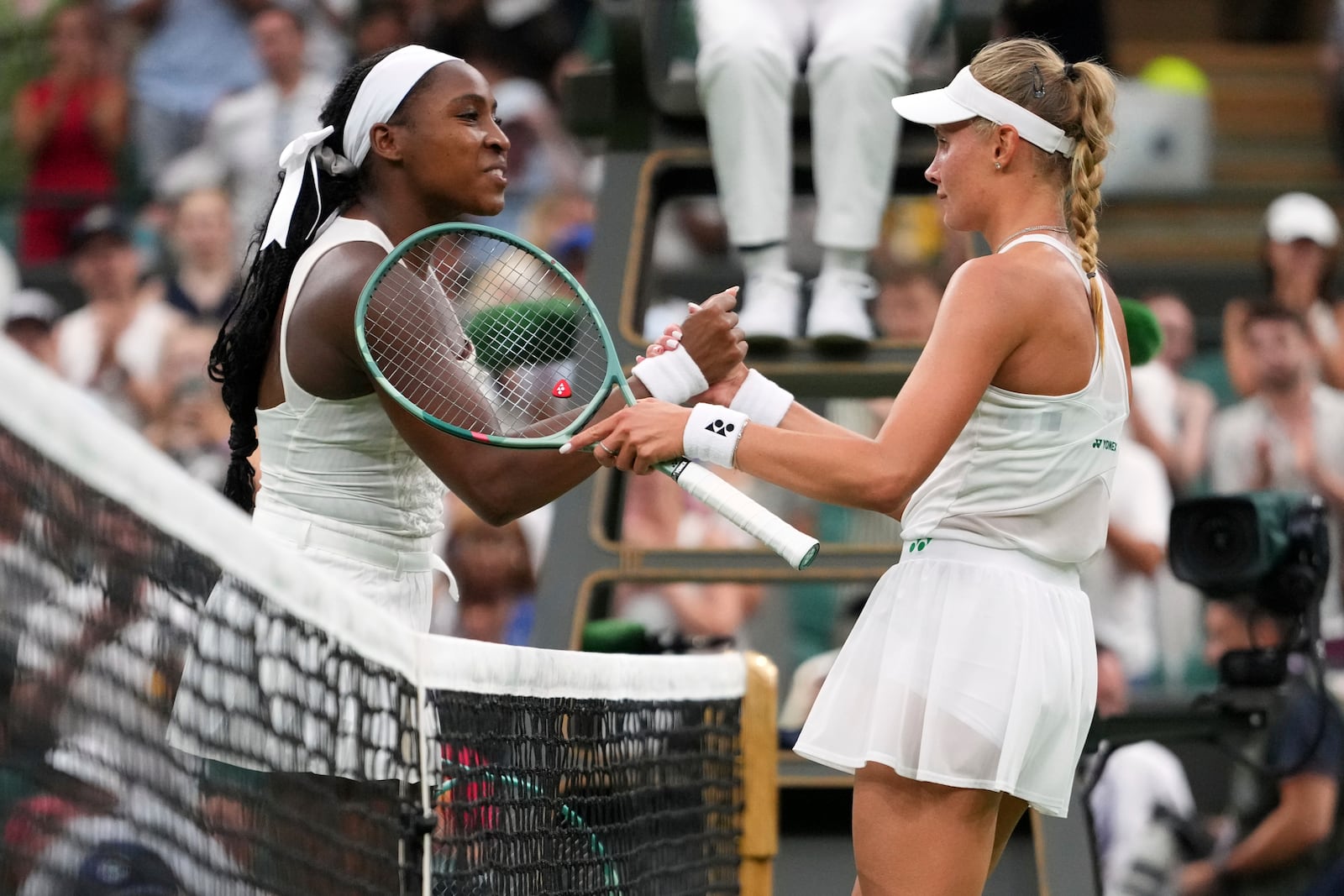 Dayana Yastremska of Ukraine shakes hands with Coco Gauff of the U.S., left, after winning the first round women's single match at the Wimbledon Tennis Championships in London, Tuesday, July 1, 2025.(AP Photo/Kirsty Wigglesworth)