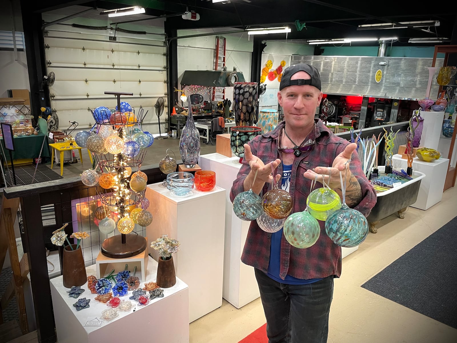 Nyminal Glass, a glass blowing studio and gallery in Dayton, is offering ornament making classes for the holiday season. Pictured is owner Dustin Wagner. NATALIE JONES/STAFF