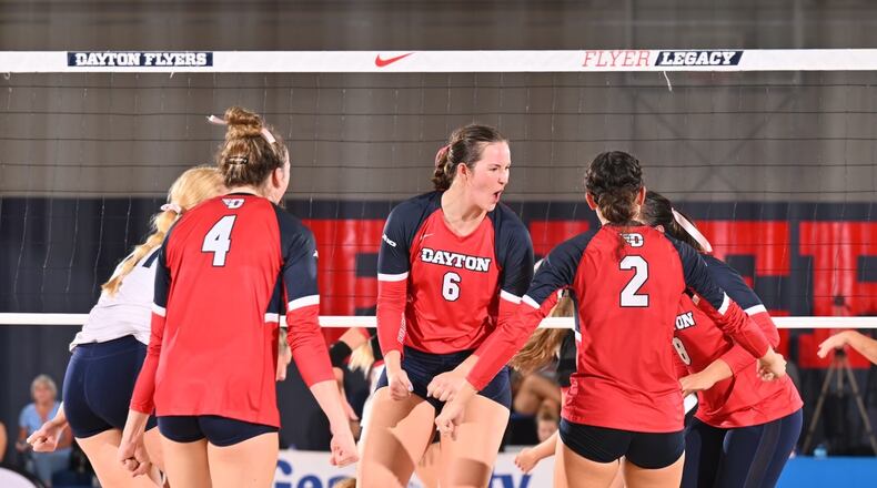 Amelia Moore, center, of the Dayton volleyball team, reacts to a point during a match against Western Kentucky at the Frericks Center on Friday, Aug. 24, 2023. Photo courtesy of University of Dayton Athletics