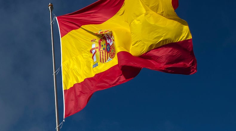FILE - The Spanish flag flies during a memorial for coronavirus (COVID-19) victims in Madrid, Spain, Friday, Oct. 23, 2020. (AP Photo/Manu Fernandez, file)