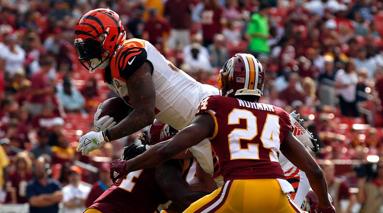 Cincinnati Bengals running back Jeremy Hill, left, dives into the end zone for a touchdown in front of Washington Redskins cornerback Josh Norman (24) in the first half of a preseason NFL football game, Sunday, Aug. 27, 2017, in Landover, Md. (AP Photo/Alex Brandon)