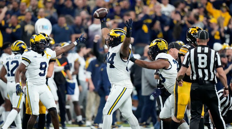 Michigan defensive lineman Kris Jenkins (94) celebrates after recovering a fumble during the first half of the Big Ten championship NCAA college football game against Iowa, Saturday, Dec. 2, 2023, in Indianapolis. (AP Photo/AJ Mast)
