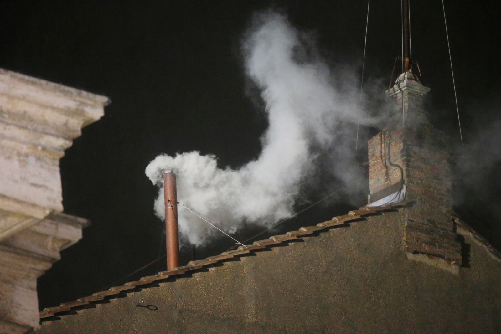 FILE - White smoke is seen billowing out from the chimney of the Sistine Chapel and announcing that a new pope has been elected on Wednesday, March 13, 2013. (AP Photo/Gregorio Borgia, File)